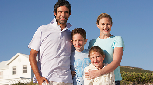Young family of four outdoors - Insurance Products and Services